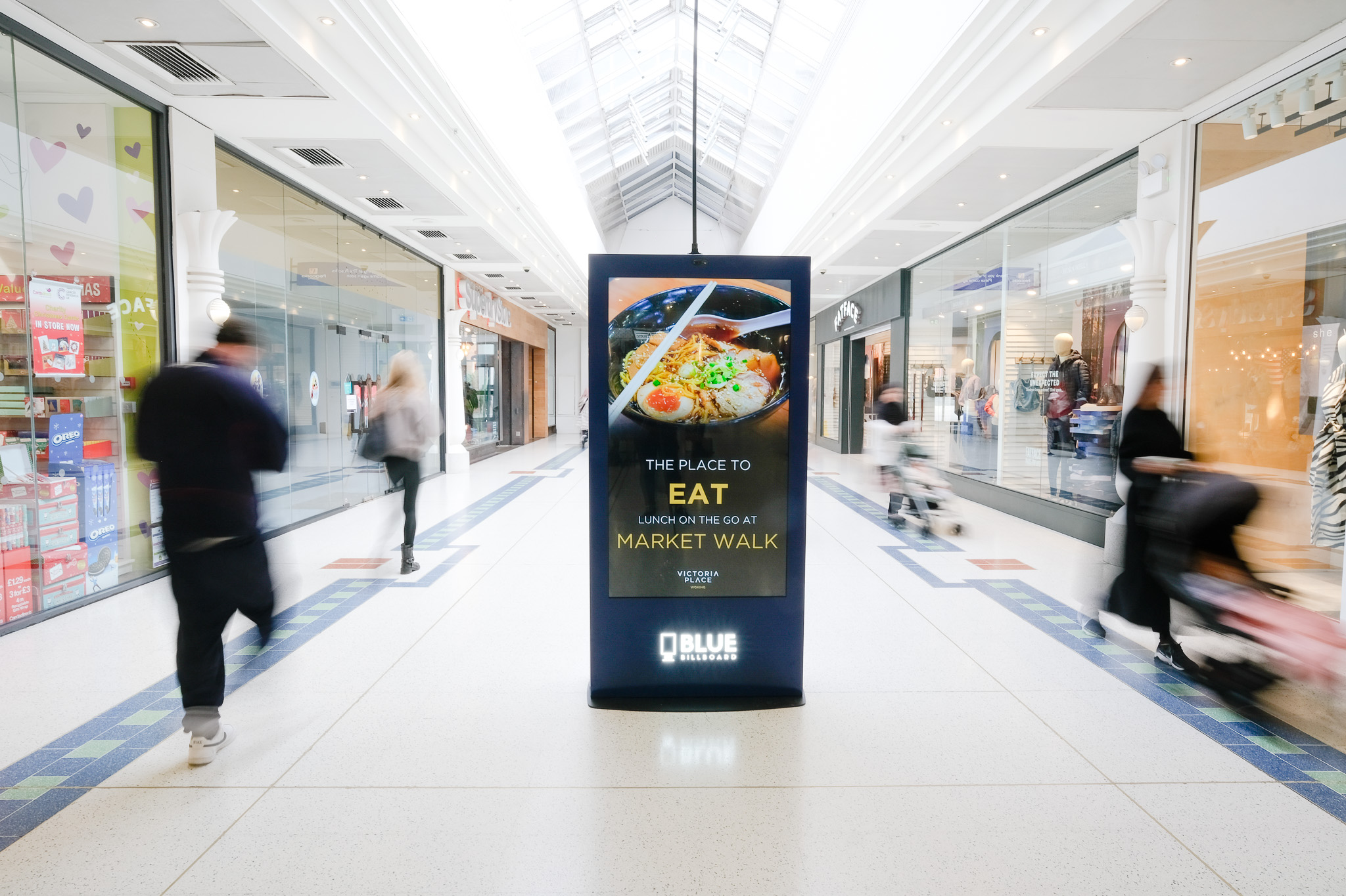 A retail digital kiosk in the middle of a shopping mall that provides innovative advertising for any product/service.