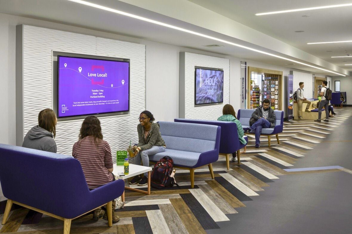 Image of a student social area with digital signage displaying event promotions